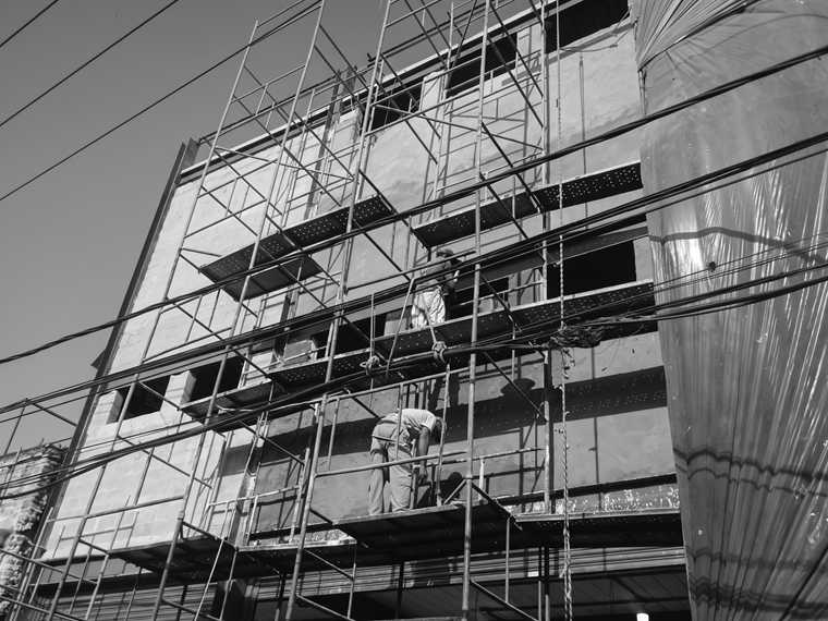Obra comercial em execução, com estrutura e andaimes